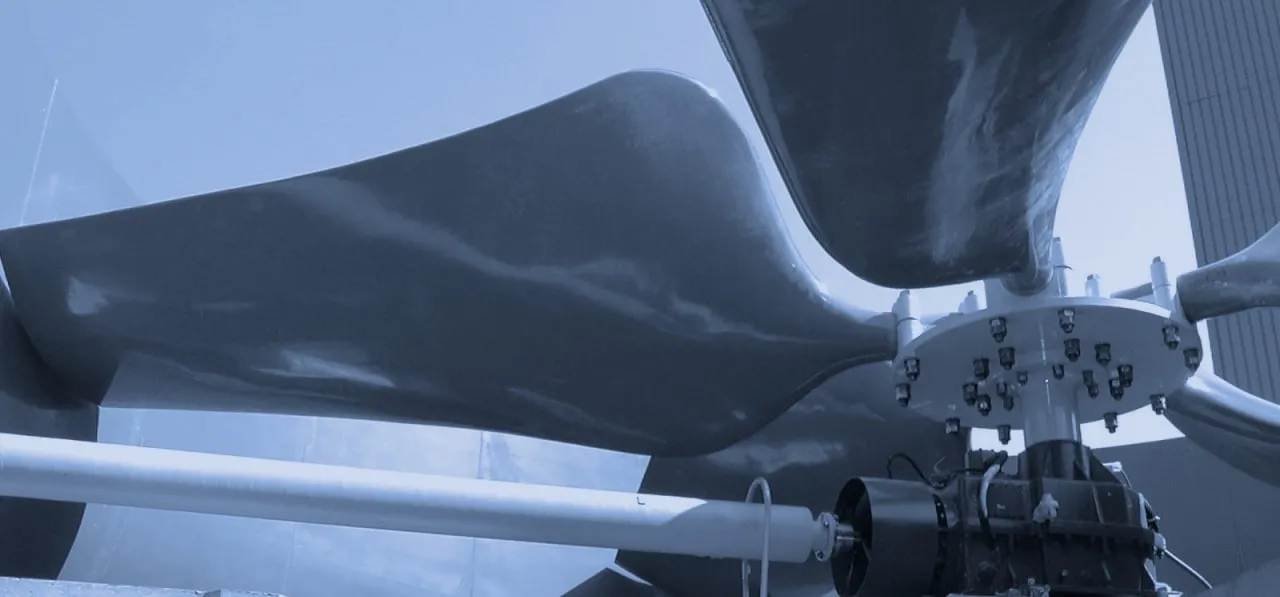 Wide FRP fan blades above the gearbox and drive shaft of a cooling tower fan