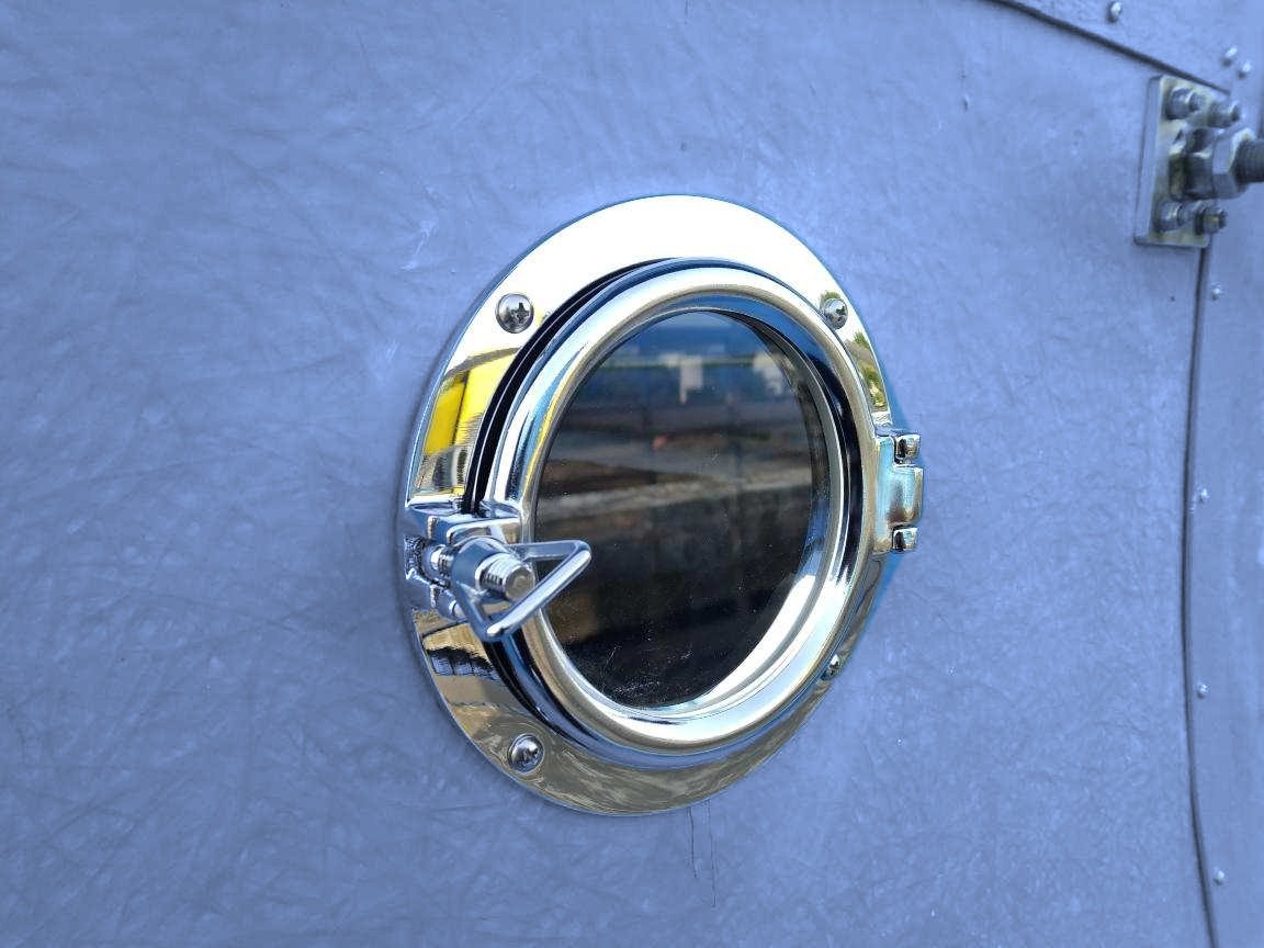 Round inspection window in a blue FRP fan stack