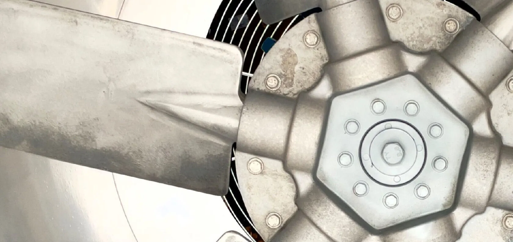 Close view of an industrial axial fan blade and hub assembly