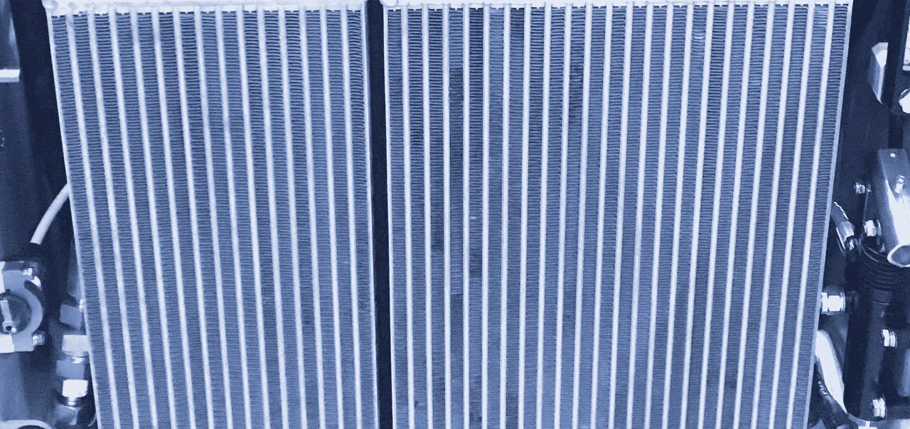 Close-up of a heat exchanger's cooling fin core installed in mobile machinery